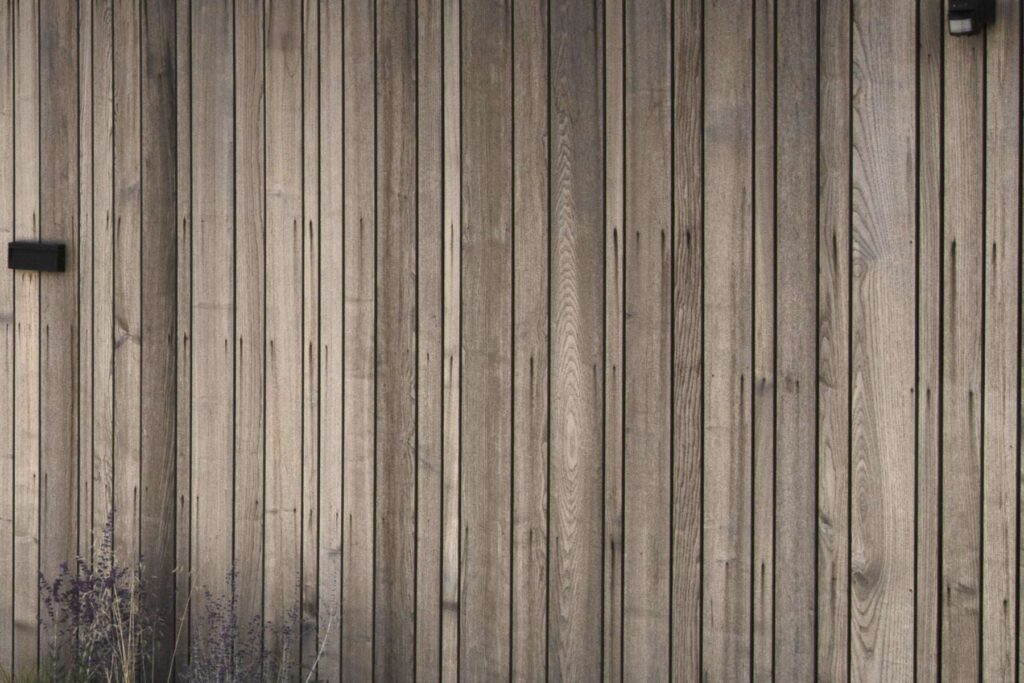 Timber cladding with unsightly stains caused by ferrous nails.